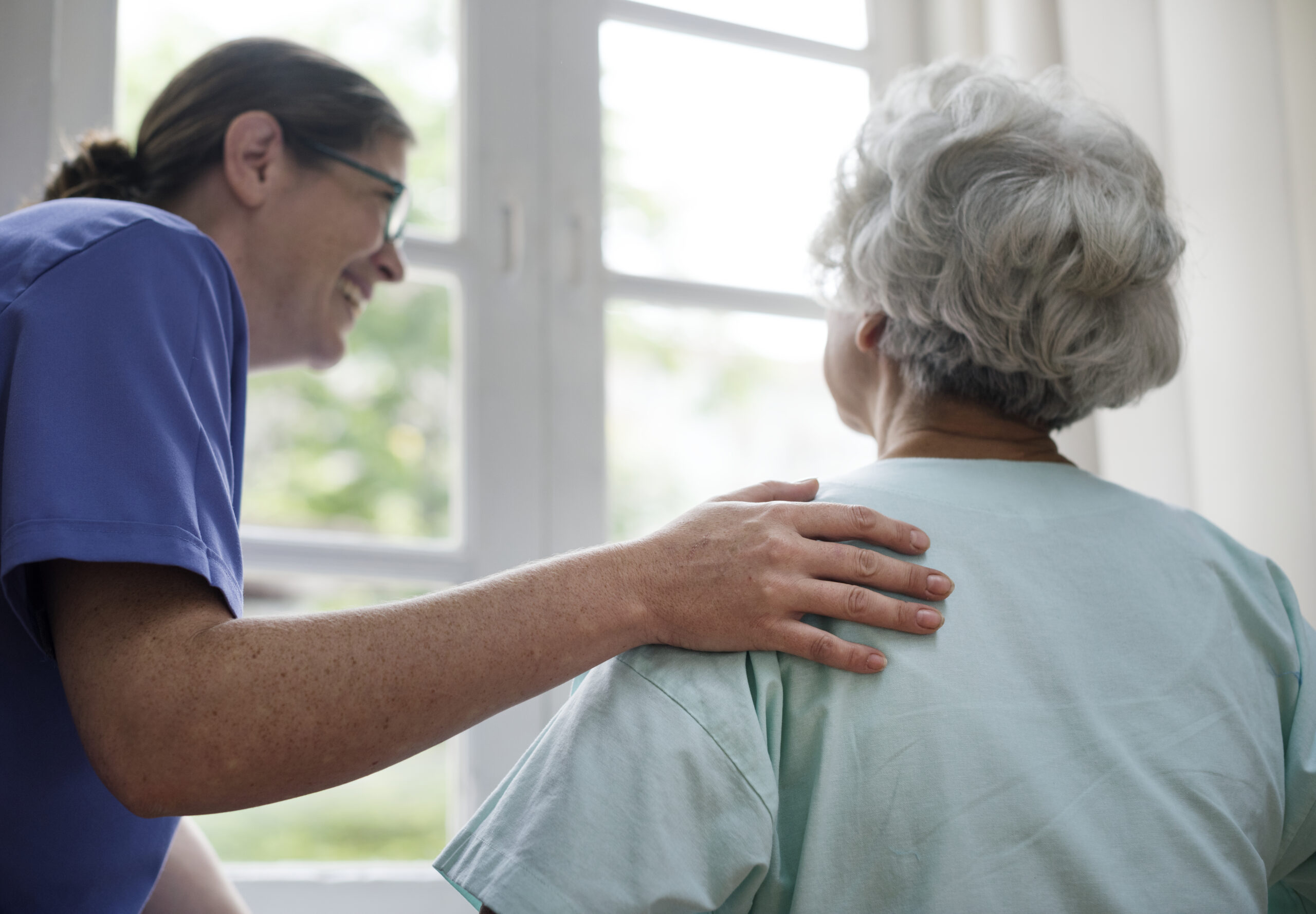 nurse taking care old woman scaled